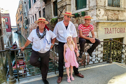 Gondoliers on a Venice bridge