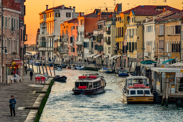 Cannaregio Canal with ACTV water bus and Alilaguna Orange Line airport boat in Venice.