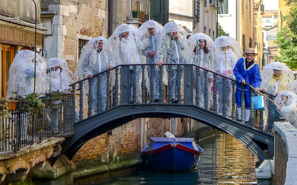 Tourists with plastic raincoats in Venice, Italy.