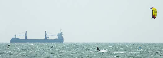 Kitesurfer and ship in Adriatic